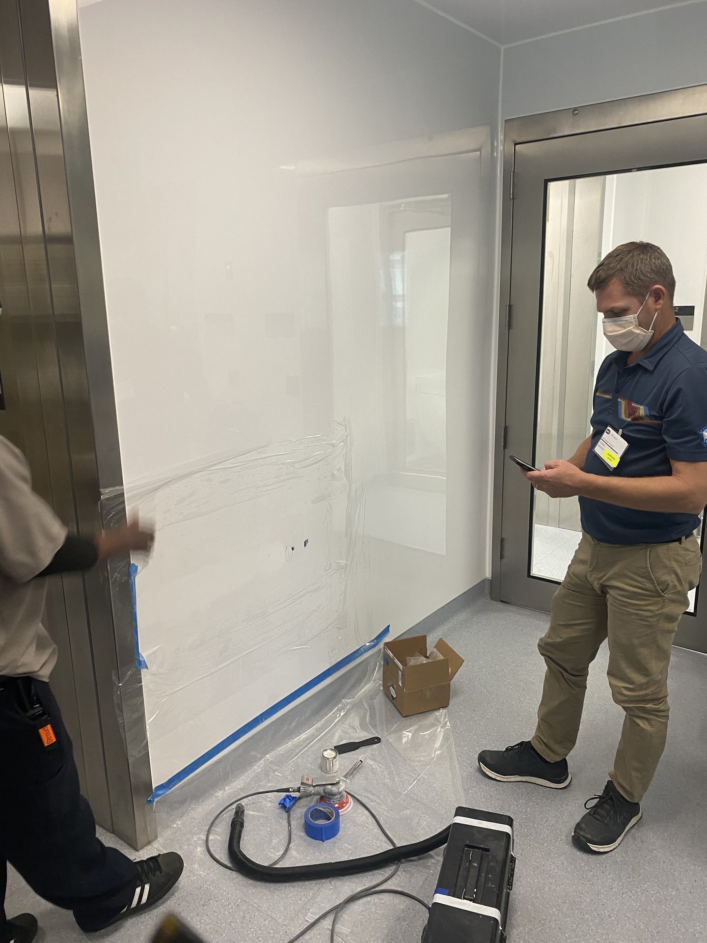 Crew finishing a seamless cleanroom wall panel