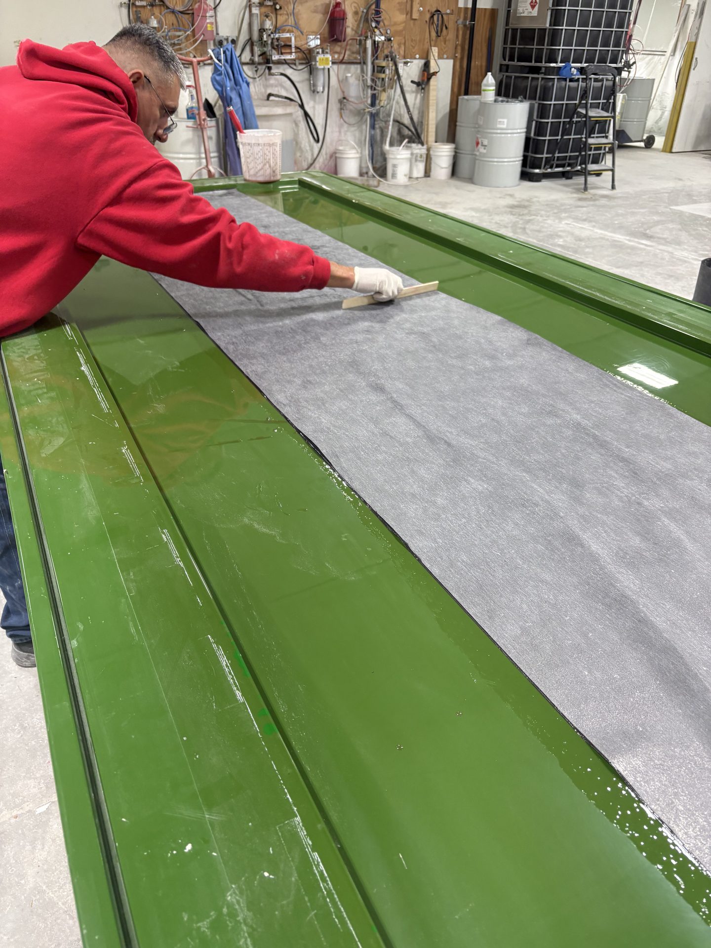 Technician smoothing reinforcement fabric by hand