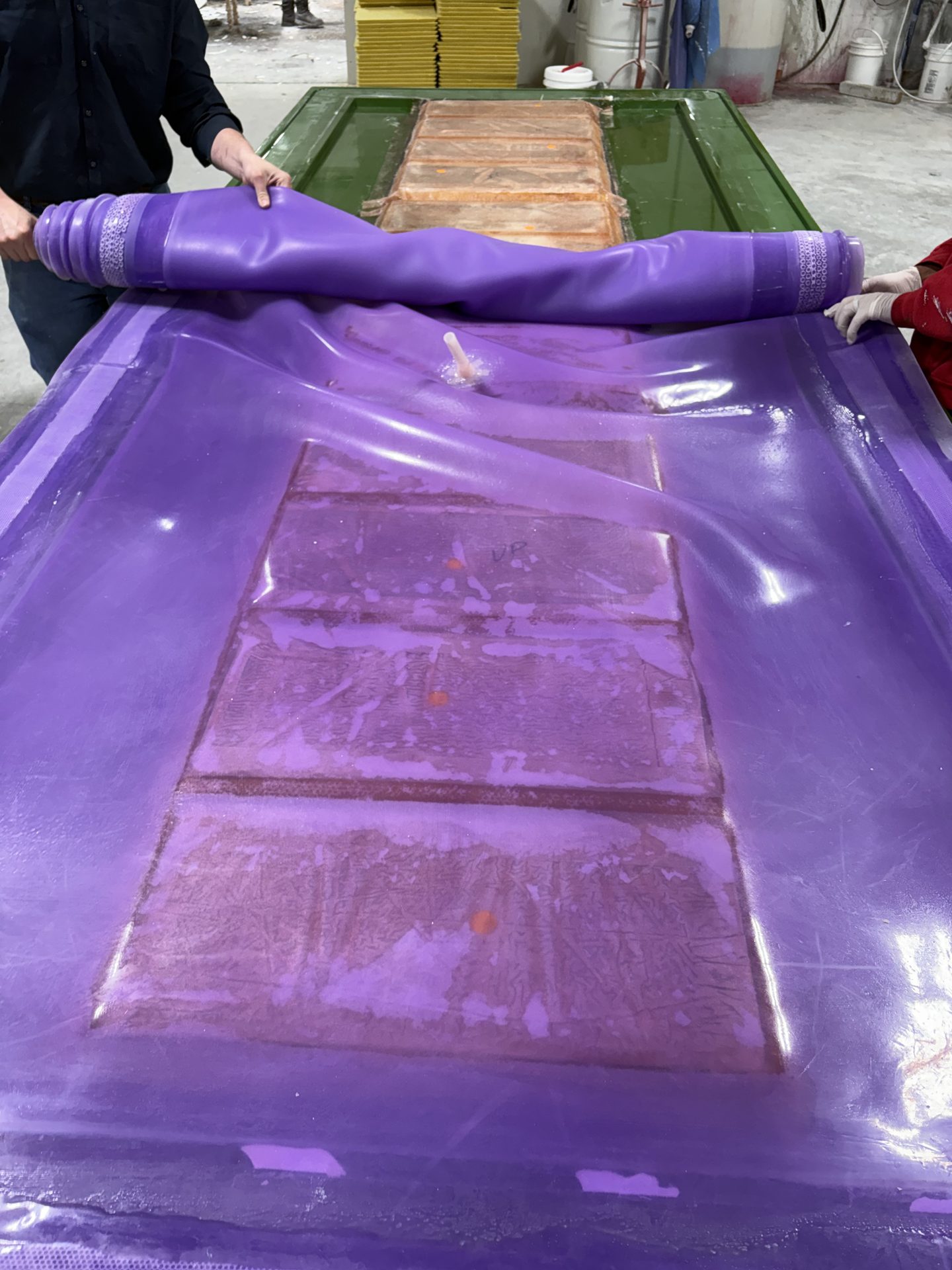 Crew closing a reusable membrane over molded panels