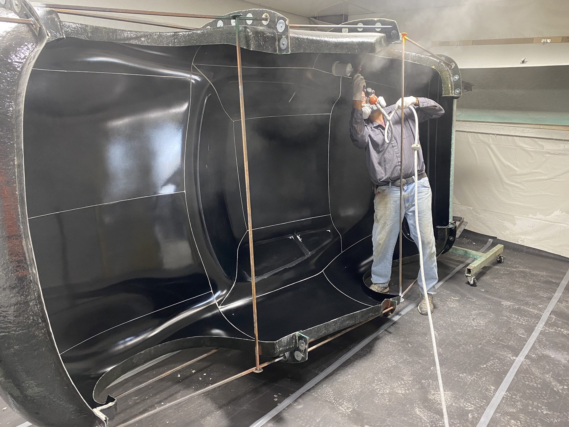 Technician prepping a large vehicle mold