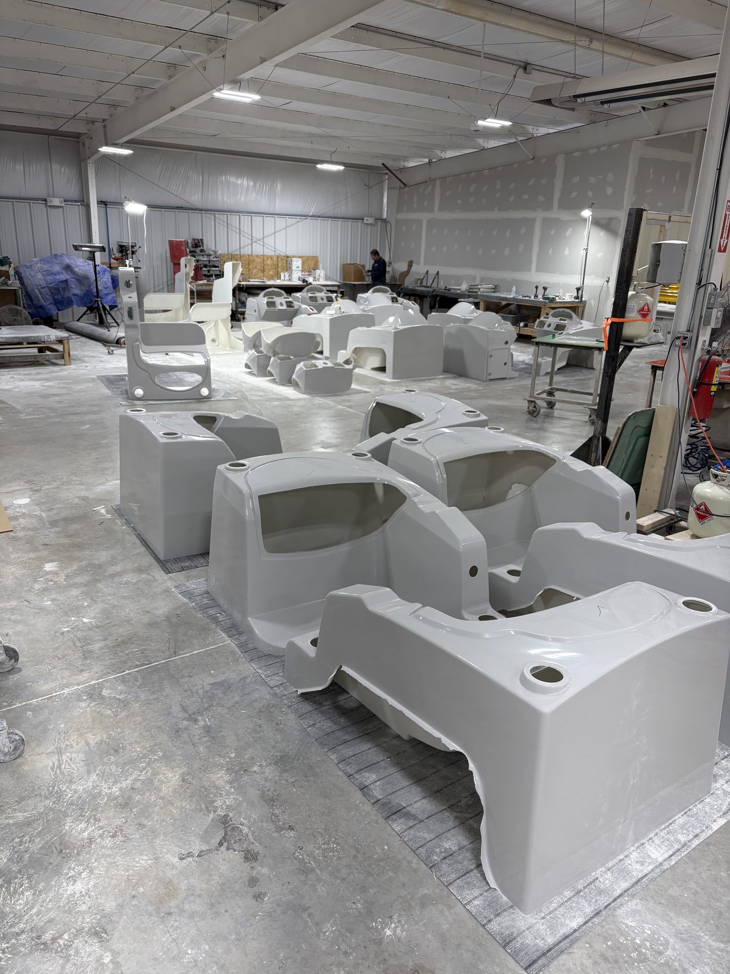 Finished molded shells staged across the production floor