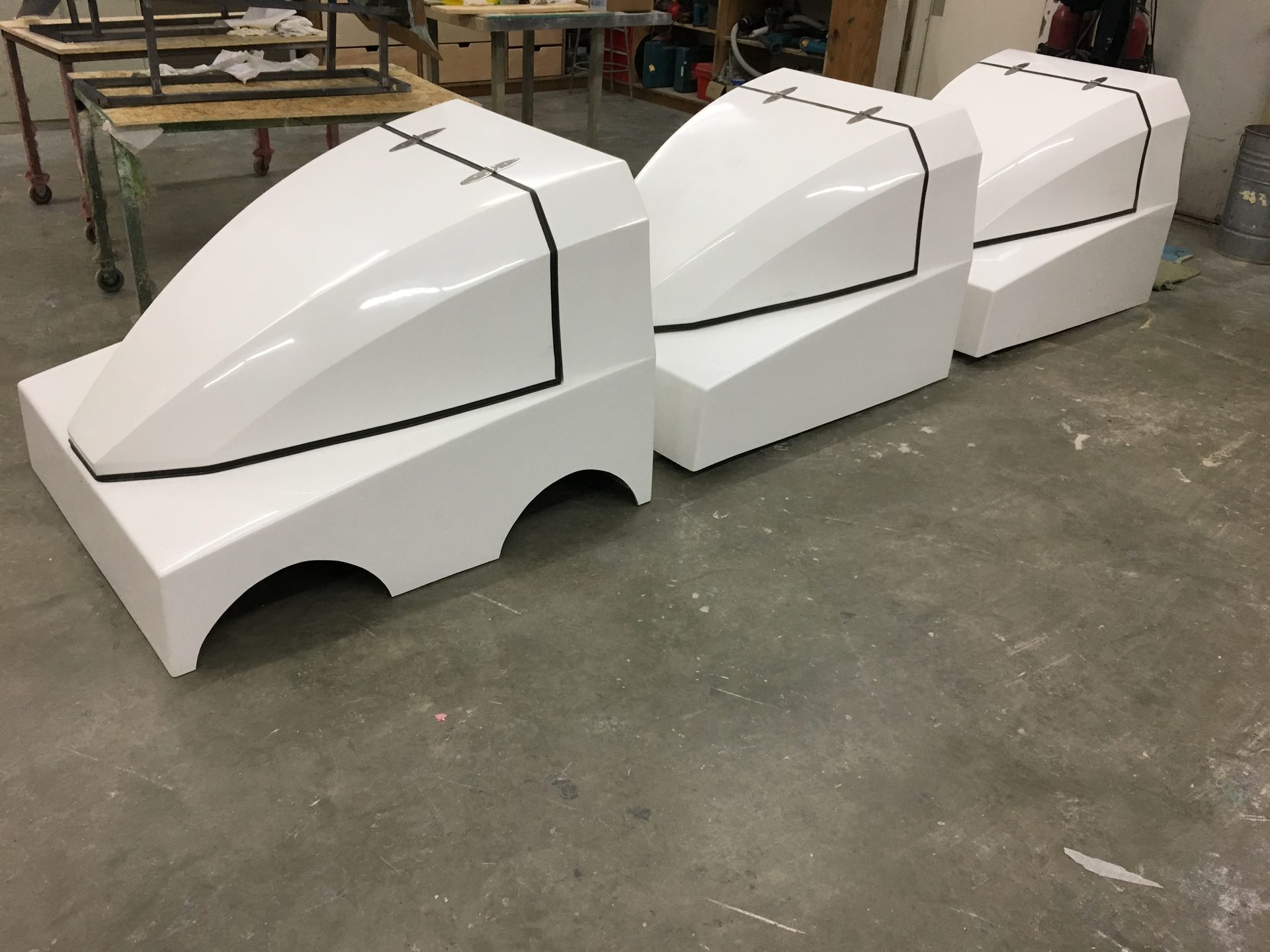 Fiberglass rover pods lined up in the shop