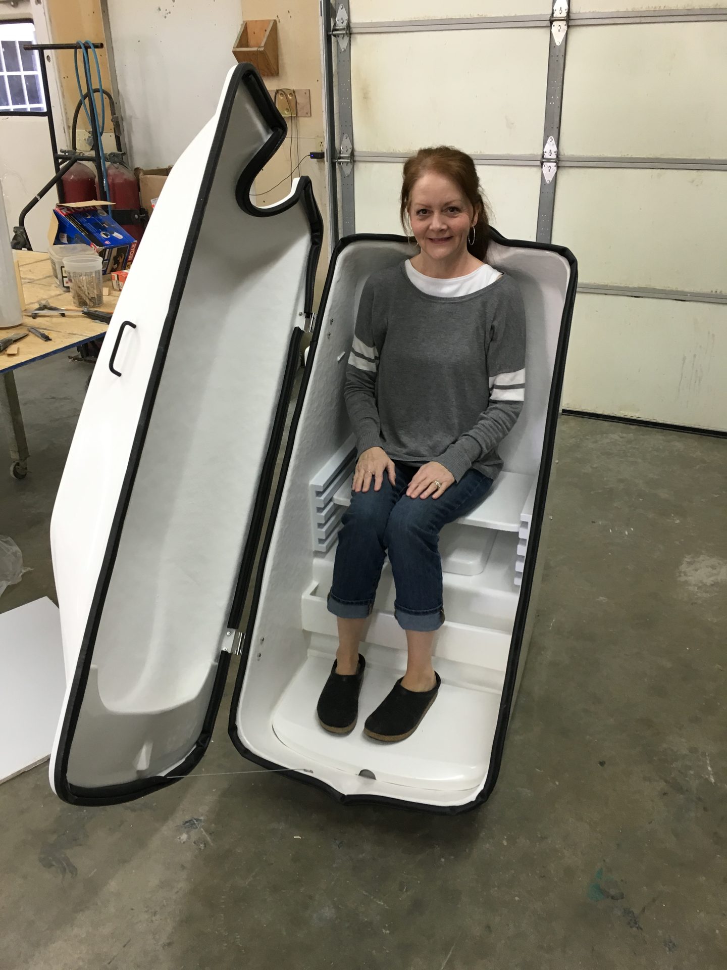 Open fiberglass sauna pod during a fit check