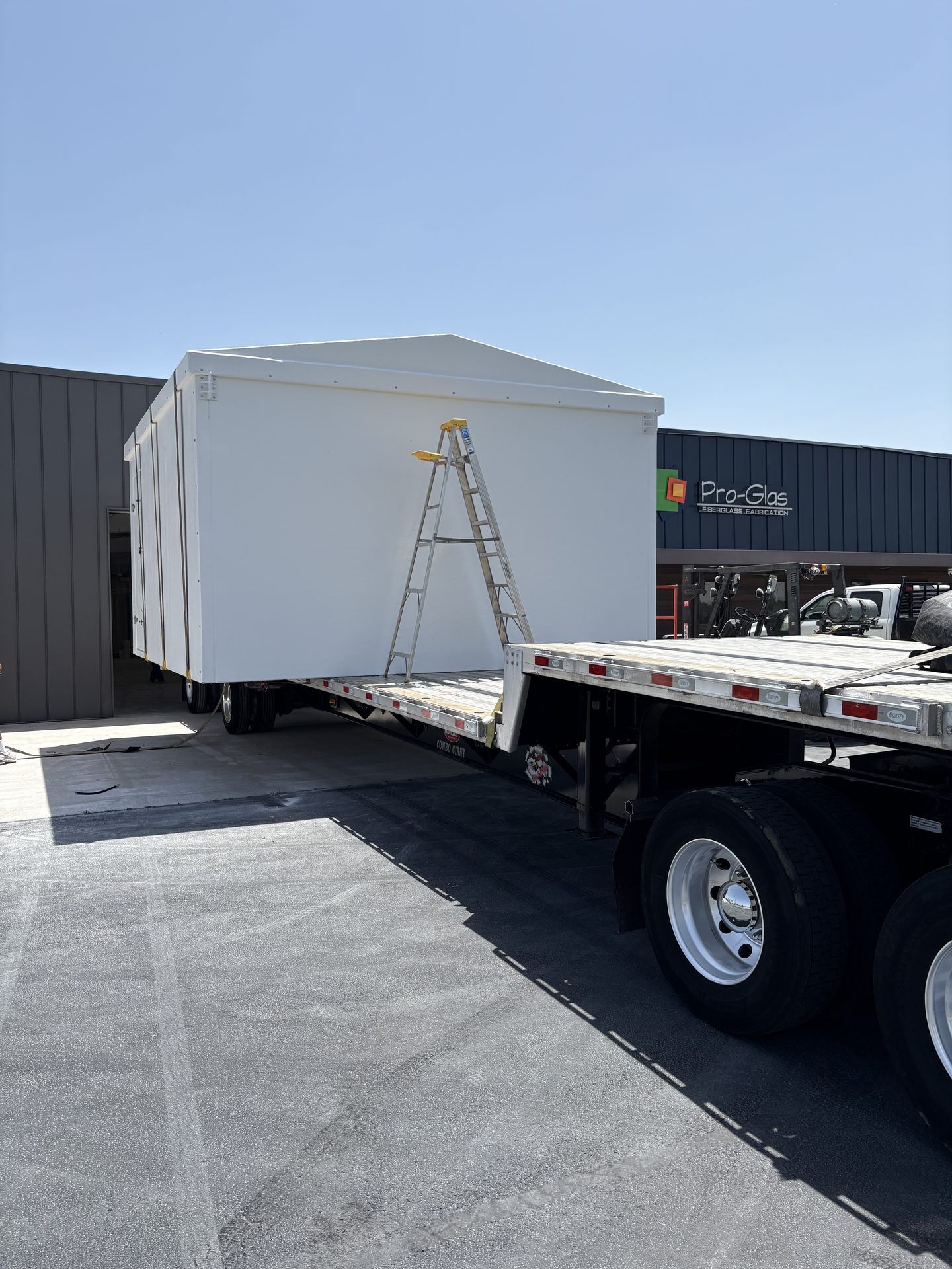 Fiberglass shelter loaded on a flatbed for delivery